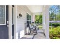 Covered front porch with rocking chairs, providing a relaxing outdoor space at 4524 Ramsey Ford Rd., Tabor City, NC 28463