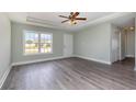 Inviting living room with wood floors, large windows, and a ceiling fan at 469 Overcrest St., Myrtle Beach, SC 29579