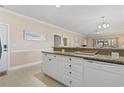 Open-concept living space features a kitchen with granite countertops, and seamlessly connects to the living and dining areas at 4803 Bovardia Pl. # 104, Myrtle Beach, SC 29577