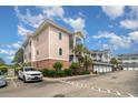 Condo complex showing garages, stairs to unit entrances, professional landscaping, and well maintained parking area at 4847 Carnation Circle # 201, Myrtle Beach, SC 29577
