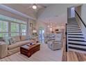 Bright living room featuring a plush sofa, hardwood floors, and an open layout leading to the kitchen at 503 20Th Ave. N # 15-A, North Myrtle Beach, SC 29582