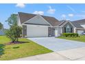 Traditional home exterior featuring a two-car garage and meticulously maintained landscaping at 5107 Capulet Circle, Myrtle Beach, SC 29588