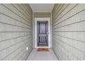 A welcoming front door with a welcome mat leading into the home at 5309 Abbey Park Loop, Myrtle Beach, SC 29579