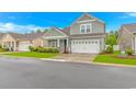 Charming two-story home with a well-manicured lawn and a two-car garage at 5309 Abbey Park Loop, Myrtle Beach, SC 29579