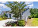 This beautiful home has a manicured lawn with lush bushes and well-kept landscaping at 5581 Plantersville Pl., Myrtle Beach, SC 29579