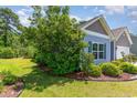 Manicured lawn and landscaping along the side of this charming home at 5581 Plantersville Pl., Myrtle Beach, SC 29579