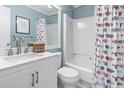Cozy bathroom with a shower-tub combo, white vanity, and a stylish nautical-themed shower curtain at 5601 N Ocean Blvd. # C-106, Myrtle Beach, SC 29577