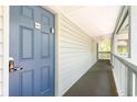 Exterior view of a hallway and front door with blue painted door and white siding at 5905 S Kings Highway # 6302, Myrtle Beach, SC 29575