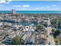 Stunning aerial view showcasing the home's proximity to the waterway and ocean, complete with a neighborhood location pin at 6001-T36 South Kings Hwy., Myrtle Beach, SC 29575
