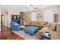 Cozy living room with hardwood floors, staircase, neutral walls, and comfortable seating, perfect for relaxation at 6001-T36 South Kings Hwy., Myrtle Beach, SC 29575
