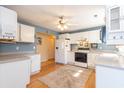 Bright kitchen featuring white cabinets, a white refrigerator, and modern appliances at 602 Six Lakes Dr., Myrtle Beach, SC 29588