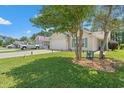 Charming single-story home with a well-manicured lawn and a two-car garage on a sunny day at 6485 Royal Pine Dr., Myrtle Beach, SC 29588