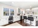 Bright, white kitchen features a breakfast bar and work space at 668 S Waccamaw Dr., Murrells Inlet, SC 29576