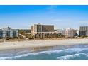 Panoramic view of the condo building on the beach, with beautiful blue ocean and sky visible in the background at 6900 North Ocean Blvd. # 1105, Myrtle Beach, SC 29572