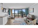 Inviting living room with stylish furniture, a flat-screen TV, and a stunning ocean view at 6900 North Ocean Blvd. # 1105, Myrtle Beach, SC 29572