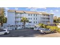 Three-story condo featuring private balconies, manicured landscaping and convenient parking at 712 Dogwood Dr. S # 101, Surfside Beach, SC 29575