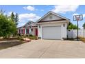 Home exterior with a well manicured lawn, attached garage, and basketball hoop at 761 Drawbridge Dr., Conway, SC 29526