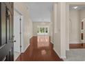 Bright foyer with hardwood floors leads to a living area with large windows for ample natural light at 832 Pembridge Ct., Myrtle Beach, SC 29579