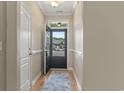 Bright foyer with wood floors, a blue rug, and natural light streaming in from the front door at 853 Derbyshire Ct., Conway, SC 29526