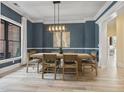 Dining room featuring wainscoting, statement chandelier, and access to the kitchen at 9449 Freewoods Rd., Myrtle Beach, SC 29588