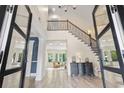 Grand foyer with hardwood floors, elegant staircase, and views into the living spaces at 9449 Freewoods Rd., Myrtle Beach, SC 29588