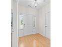 Bright foyer with hardwood floors, a white front door, and sidelights, creating a welcoming entrance at 962 Witherbee Way, Little River, SC 29566