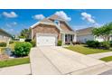 Inviting home with a stone facade, complemented by a lush lawn and a spacious driveway leading to the garage at 962 Witherbee Way, Little River, SC 29566