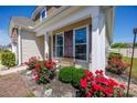 Charming covered front porch with seasonal flowers, offering a cozy spot to relax and enjoy the neighborhood views at 962 Witherbee Way, Little River, SC 29566
