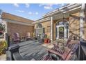 Inviting front porch with comfortable seating, providing a cozy spot to welcome guests and enjoy the outdoors at 9628 Indigo Creek Blvd., Murrells Inlet, SC 29576