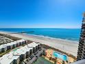 An aerial view of the condo building, showcasing the pool, beach, and ocean views at 9650 Shore Dr. # 2007, Myrtle Beach, SC 29572