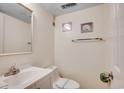 Bathroom features a toilet with paper safety band, seashell decor, and vanity at 1012 N Waccamaw Dr. # 301, Garden City Beach, SC 29576