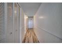 Hallway includes wood look floors and large closet storage at 1012 N Waccamaw Dr. # 301, Garden City Beach, SC 29576
