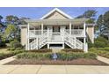 Charming condo featuring a double staircase leading to inviting upper-level entrances, complemented by landscaped greenery at 1041 Blue Stem Dr. # 37A, Pawleys Island, SC 29585