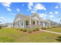 Beautiful, well-maintained single-Gathering home with manicured lawn, landscaping and inviting front porch at 1048 Longwood Bluffs Circle, Murrells Inlet, SC 29576