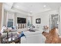 Bright and airy living room featuring hardwood floors, tray ceilings and ample natural light at 1048 Longwood Bluffs Circle, Murrells Inlet, SC 29576