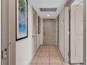 Hallway with neutral walls, a tiled floor, and beach themed artwork at 107 S Ocean Blvd. # 1001, Myrtle Beach, SC 29577