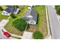 An aerial view of a well-kept home featuring a backyard, driveway, street, and manicured front lawn at 1108 Blue Juniper Ct., Conway, SC 29527