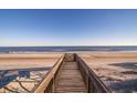 Wooden walkway providing direct access to a pristine sandy beach and ocean at 1184 Parker Dr., Pawleys Island, SC 29585