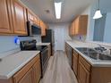 Well-organized kitchen featuring stainless steel appliances, wood cabinets, and ample counter space at 119 Brentwood Dr. # D, Murrells Inlet, SC 29576