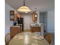 Charming kitchen with wood cabinets, black appliances, and a cozy dining area for casual meals at 119 Brentwood Dr. # D, Murrells Inlet, SC 29576