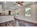 Open-concept living area boasts stylish flooring, ceiling fan, and lots of natural light at 120 Triston Ct., Little River, SC 29566