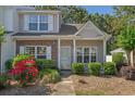 Townhome exterior with brick details, neatly trimmed shrubs, and a clear pathway to the front door at 1249 Shoebridge Dr. # 1249, Myrtle Beach, SC 29579