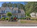 Inviting townhome with lush landscaping, flowering bushes, and a well-manicured front yard at 1249 Shoebridge Dr. # 1249, Myrtle Beach, SC 29579