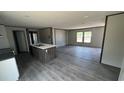 Open-concept living area featuring wood-look floors with an island with bar seating at 1300 Rabbit Ln., Conway, SC 29526