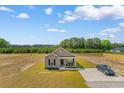 Aerial view of a single-story home, showcasing the large yard and long driveway at 1396 Highway 129, Galivants Ferry, SC 29544