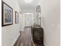 Elegant hallway with hardwood floors, decorative mirror, and stylish decor at 179 Hyacinth Loop, Murrells Inlet, SC 29576