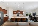 Open kitchen featuring a large island with seating and modern appliances next to the dining area at 179 Hyacinth Loop, Murrells Inlet, SC 29576