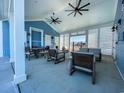 Covered lounge area equipped with ceiling fans, comfortable seating, and tables for residents at 2158 Gooseberry Way, Longs, SC 29568