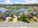 Aerial view of lakeside homes featuring manicured lawns, mature trees, and beautiful water views at 220 Waterfall Circle, Little River, SC 29566