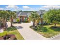 Stunning brick house with mature trees, a driveway with brick pavers, and meticulous landscaping at 220 Waterfall Circle, Little River, SC 29566